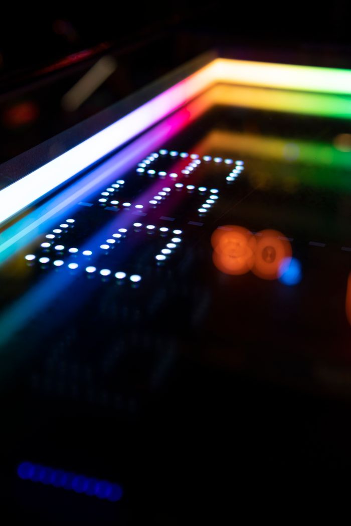 Vibrant arcade machine display with colorful illuminated numbers, perfect for gaming themes.